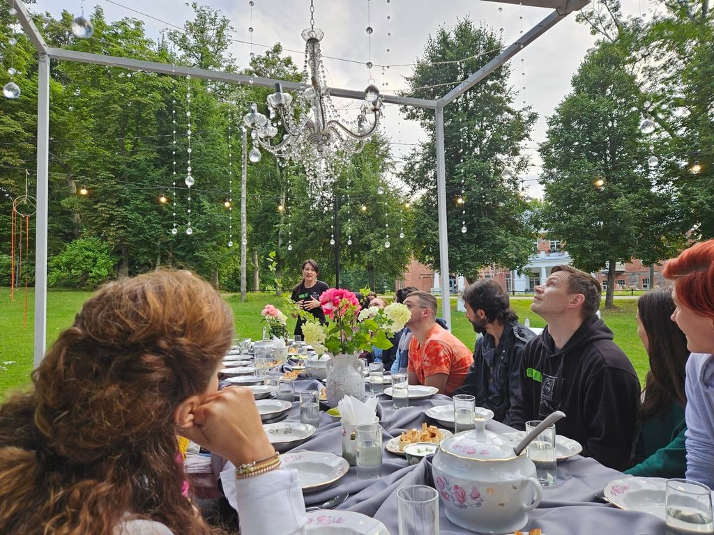 Participants sharing a communal outdoor experience at Lūznava Manor